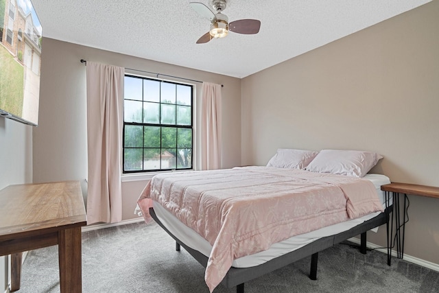 carpeted bedroom featuring a textured ceiling, baseboards, and a ceiling fan