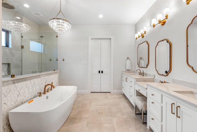 full bathroom with recessed lighting, double vanity, a shower stall, and a sink