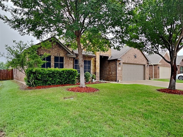 ranch-style home with a garage, fence, a front lawn, brick siding, and driveway