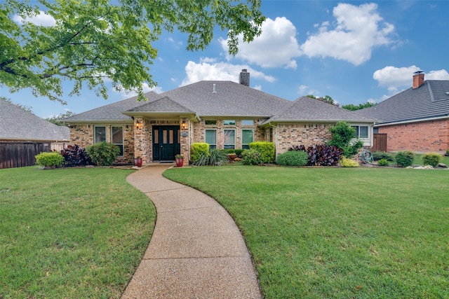 2605 Nighthawk Dr, Plano, TX 75025 - view of front of house with fence, a chimney, brick siding, and a front yard