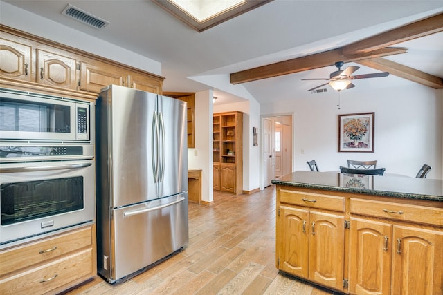 2605 Nighthawk Dr, Plano, TX 75025 - kitchen featuring ceiling fan, visible vents, dark countertops, stainless steel appliances, and beam ceiling