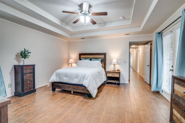 2605 Nighthawk Dr, Plano, TX 75025 - bedroom featuring a raised ceiling, visible vents, and light wood-style floors