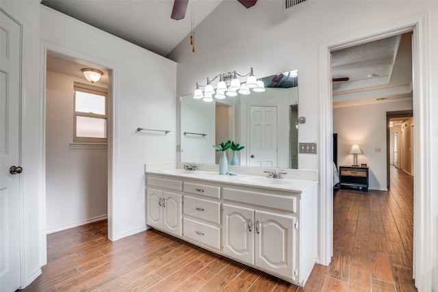 2605 Nighthawk Dr, Plano, TX 75025 - bathroom with double vanity, wood finished floors, ceiling fan, and a sink