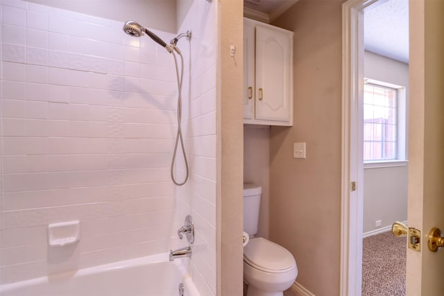 full bathroom with toilet, baseboards, and bathing tub / shower combination