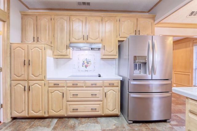 kitchen with stainless steel fridge, light brown cabinets, visible vents, under cabinet range hood, and light countertops