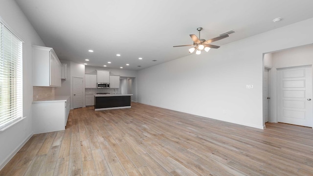 233 Pintail Ln, Rhome, TX 76078 - unfurnished living room with plenty of natural light, ceiling fan, light wood-type flooring, recessed lighting, and baseboards