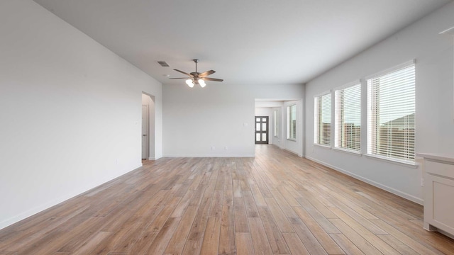 233 Pintail Ln, Rhome, TX 76078 - unfurnished living room featuring baseboards, a ceiling fan, and light wood-style floors