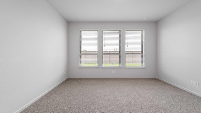 233 Pintail Ln, Rhome, TX 76078 - empty room with carpet, baseboards, and healthy amount of natural light