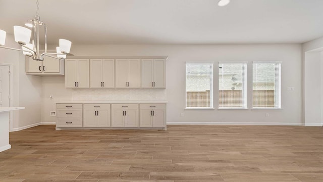 122 Palo Duro Bnd, Rhome, TX 76078 - kitchen with a chandelier, pendant lighting, light wood-style flooring, and light countertops