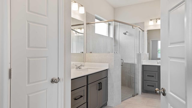 122 Palo Duro Bnd, Rhome, TX 76078 - bathroom featuring two vanities, a shower stall, and tile patterned floors