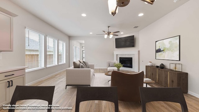 122 Palo Duro Bnd, Rhome, TX 76078 - living room with ceiling fan, a glass covered fireplace, light wood-style flooring, and recessed lighting