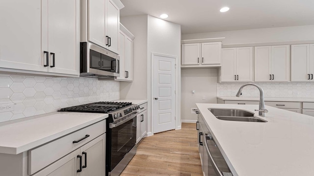 122 Palo Duro Bnd, Rhome, TX 76078 - kitchen featuring stainless steel appliances, light wood-style flooring, light countertops, recessed lighting, and tasteful backsplash