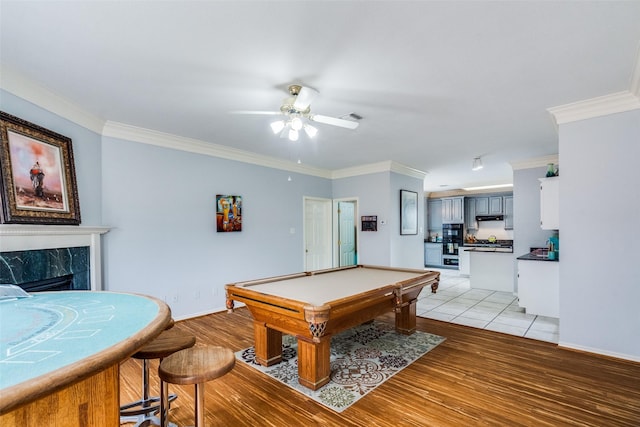4219 Voss Hills Pl, Dallas, TX 75287 - playroom featuring light wood-style flooring, a fireplace, ceiling fan, billiards, and ornamental molding