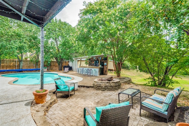 4219 Voss Hills Pl, Dallas, TX 75287 - view of swimming pool with a patio, a fire pit, outdoor dry bar, a fenced backyard, and a fenced in pool