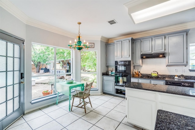 4219 Voss Hills Pl, Dallas, TX 75287 - kitchen with an inviting chandelier, light tile patterned floors, visible vents, black appliances, and ornamental molding