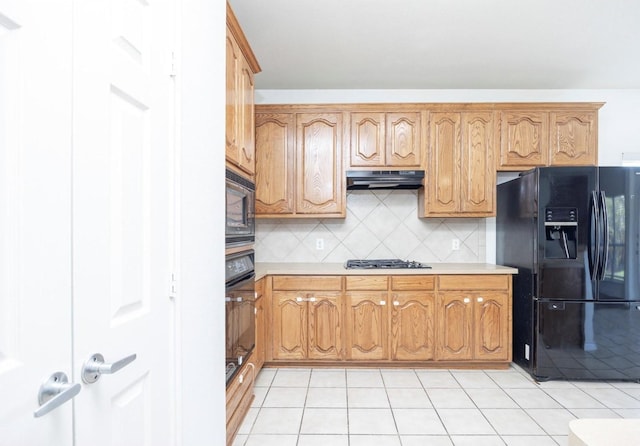 11805 Chaparral Dr, Frisco, TX 75035 - kitchen featuring black appliances, under cabinet range hood, light countertops, backsplash, and light tile patterned flooring
