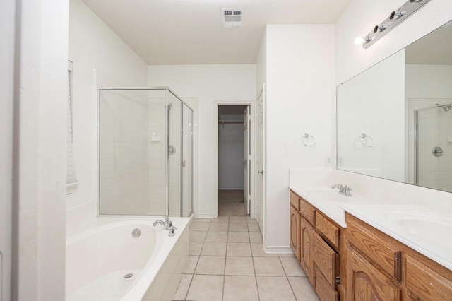 11805 Chaparral Dr, Frisco, TX 75035 - bathroom featuring a shower stall, tile patterned floors, double vanity, a bath, and a spacious closet