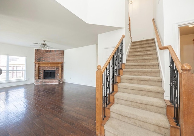 11805 Chaparral Dr, Frisco, TX 75035 - stairs with wood-type flooring, a ceiling fan, a fireplace, and baseboards