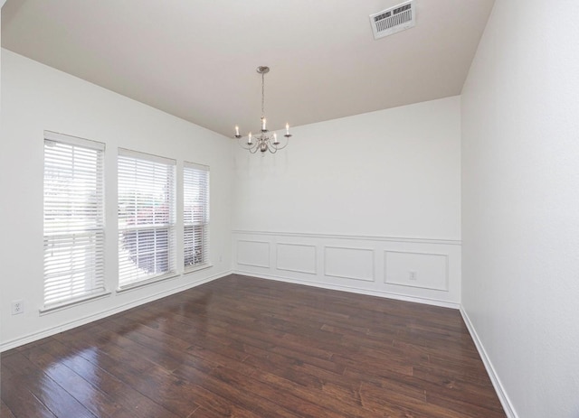 11805 Chaparral Dr, Frisco, TX 75035 - unfurnished room with a chandelier, lofted ceiling, dark wood-style flooring, and a wainscoted wall
