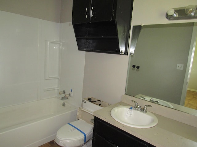 bathroom with toilet, vanity, and shower / washtub combination