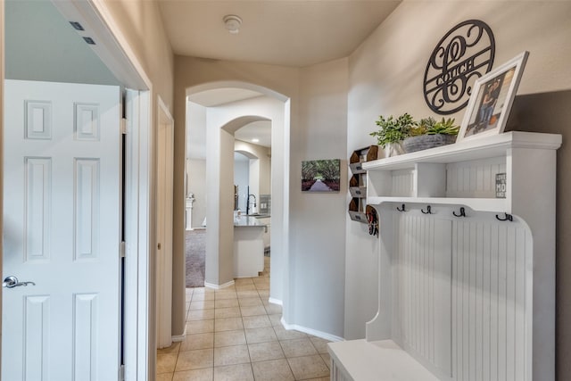 1330 Canyon Creek Rd, Wylie, TX 75098 - mudroom with light tile patterned floors, baseboards, and arched walkways