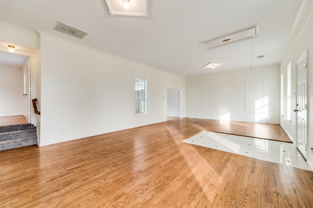875 Country Club Rd, Lucas, TX 75002 - empty room with wood finished floors, ornamental molding, attic access, visible vents, and stairway