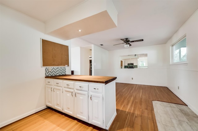 875 Country Club Rd, Lucas, TX 75002 - kitchen with light wood-style flooring, wooden counters, ceiling fan, a peninsula, and decorative backsplash