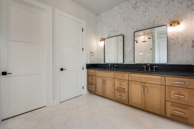 235 E Nash St Unit 118, Grapevine, TX 76051 - bathroom featuring double vanity, tile patterned flooring, a stall shower, and a sink