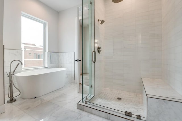 235 E Nash St Unit 118, Grapevine, TX 76051 - full bathroom featuring a stall shower, a soaking tub, marble finish floor, and plenty of natural light