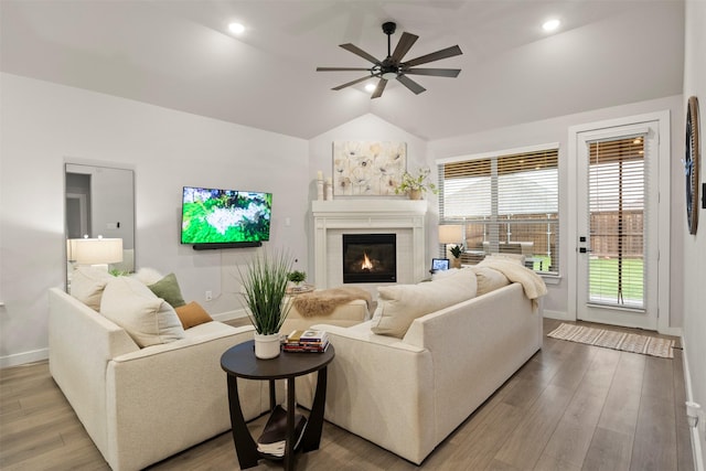 421 Hummingbird Dr, Celina, TX 75009 - living room with baseboards, a glass covered fireplace, lofted ceiling, ceiling fan, and wood finished floors