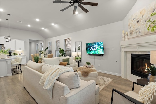 421 Hummingbird Dr, Celina, TX 75009 - living room with lofted ceiling, ceiling fan, recessed lighting, a brick fireplace, and light wood-type flooring