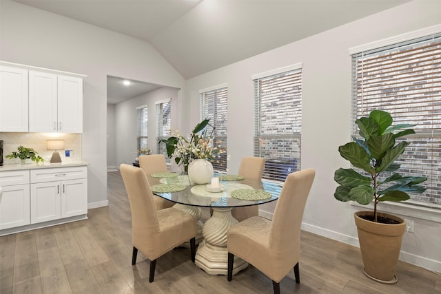 421 Hummingbird Dr, Celina, TX 75009 - dining room with baseboards, light wood-style flooring, and lofted ceiling