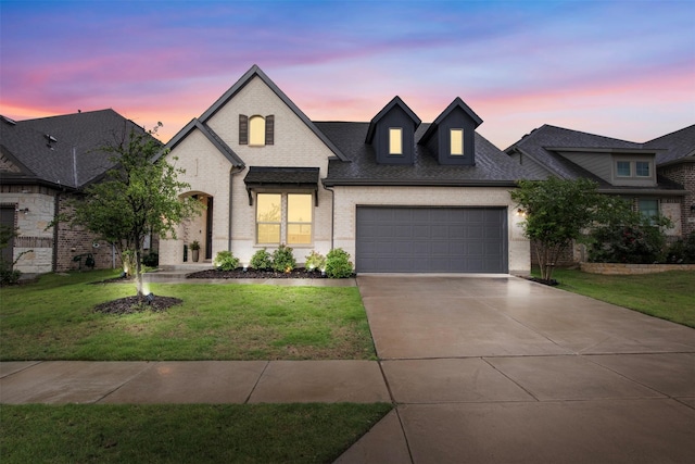 421 Hummingbird Dr, Celina, TX 75009 - french country style house with driveway, brick siding, a front yard, a garage, and a shingled roof