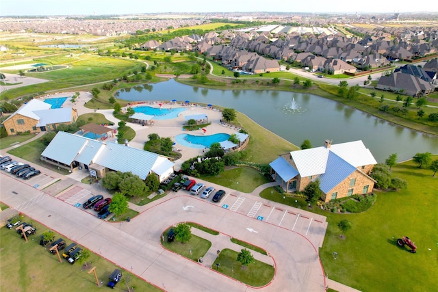 drone / aerial view with a water view and a residential view