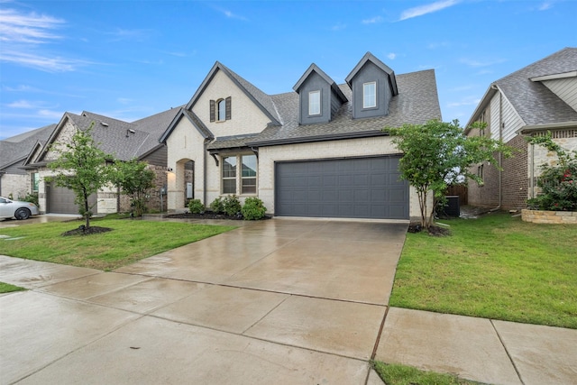 421 Hummingbird Dr, Celina, TX 75009 - view of front of property featuring an attached garage, concrete driveway, a front lawn, and brick siding