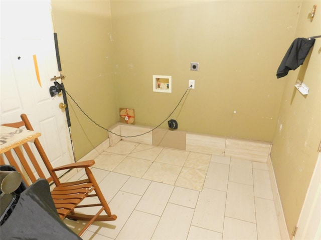 clothes washing area featuring light tile patterned floors, baseboards, washer hookup, laundry area, and electric dryer hookup