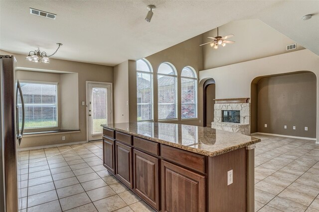 kitchen with light tile patterned floors, freestanding refrigerator, and visible vents
