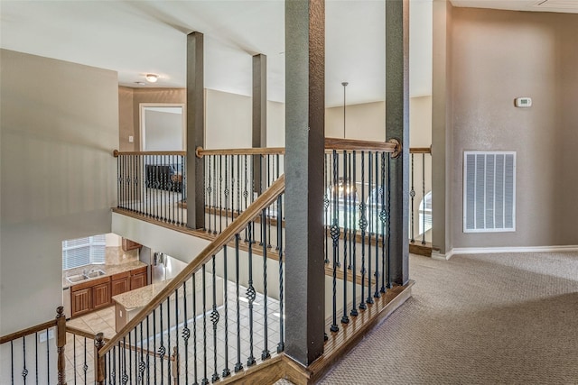 staircase with baseboards, carpet flooring, and visible vents