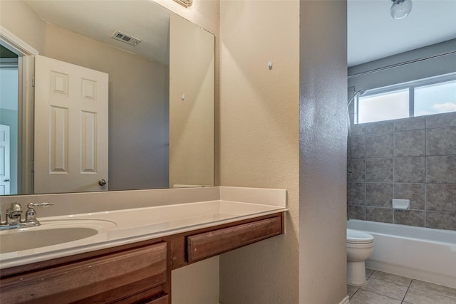 bathroom with toilet, tile patterned floors, visible vents, a textured wall, and vanity