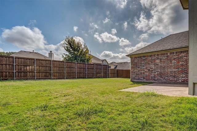 view of yard featuring a patio area and a fenced backyard