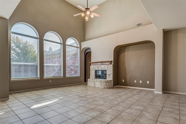 unfurnished living room with ceiling fan, tile patterned floors, a healthy amount of sunlight, and visible vents
