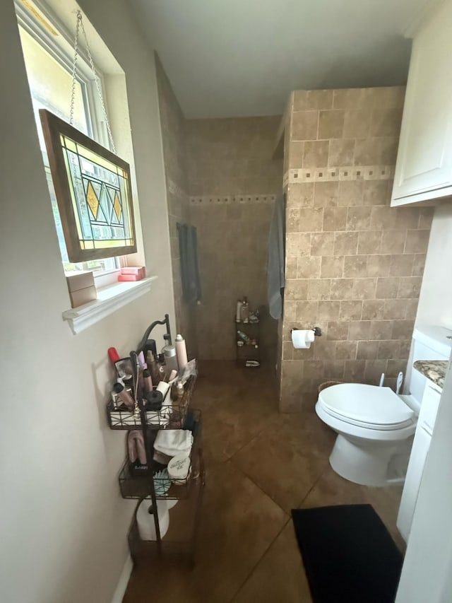 1104 County Road 701, Cleburne, TX 76031 - full bath with tile patterned flooring, tile walls, toilet, and a shower