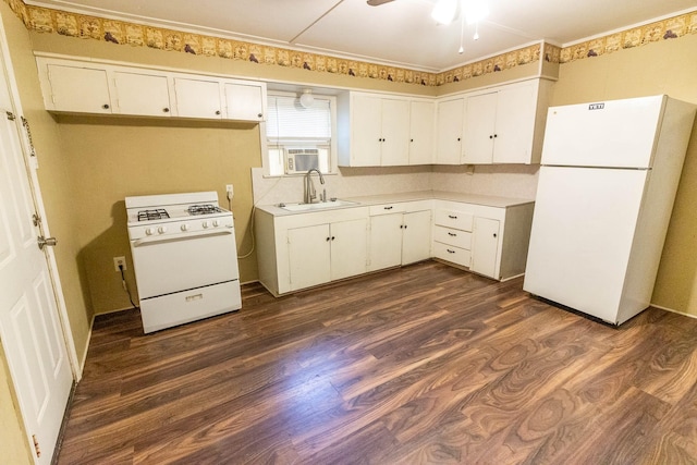 303 E 8th St, Kaufman, TX 75142 - kitchen with white appliances, a sink, white cabinetry, dark wood-type flooring, and light countertops