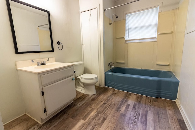 303 E 8th St, Kaufman, TX 75142 - bathroom featuring toilet, vanity, tub / shower combination, and wood finished floors