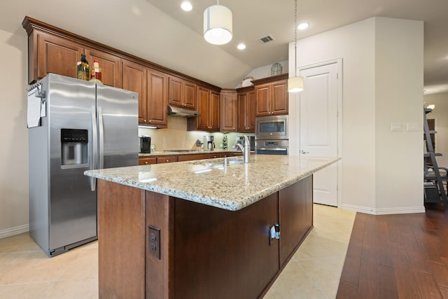 kitchen featuring a sink, light stone countertops, hanging light fixtures, baseboards, and appliances with stainless steel finishes