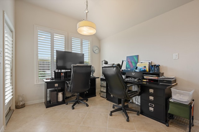 office space featuring baseboards, lofted ceiling, and light tile patterned flooring