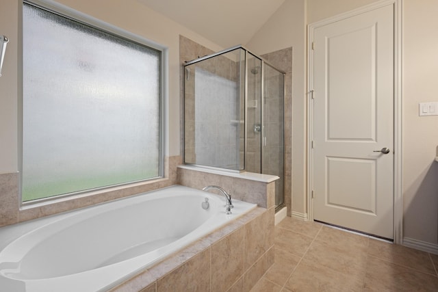 full bathroom featuring a bath, tile patterned flooring, a stall shower, and lofted ceiling