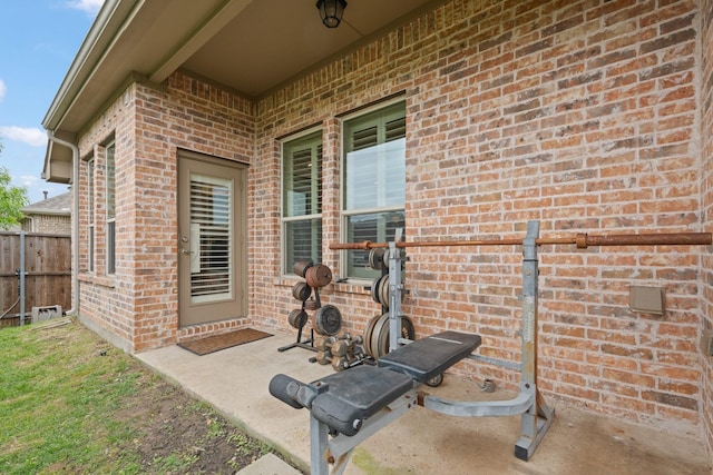workout area featuring brick wall