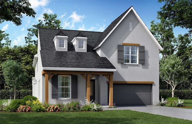 view of front of house featuring an attached garage, a shingled roof, a front yard, brick siding, and driveway