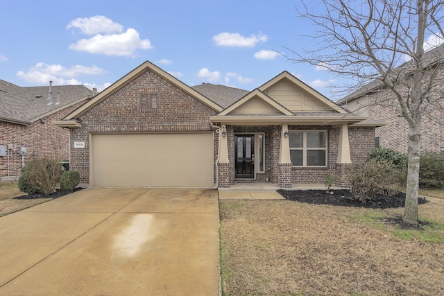 single story home featuring driveway, brick siding, a garage, a porch, and roof with shingles
